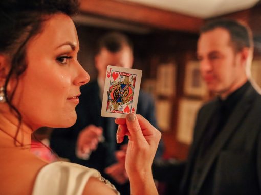 Guest holding Jack of Hearts card during close-up magic